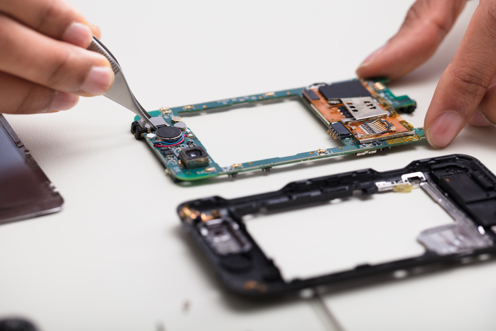 Technician Repairing Damaged Smartphone